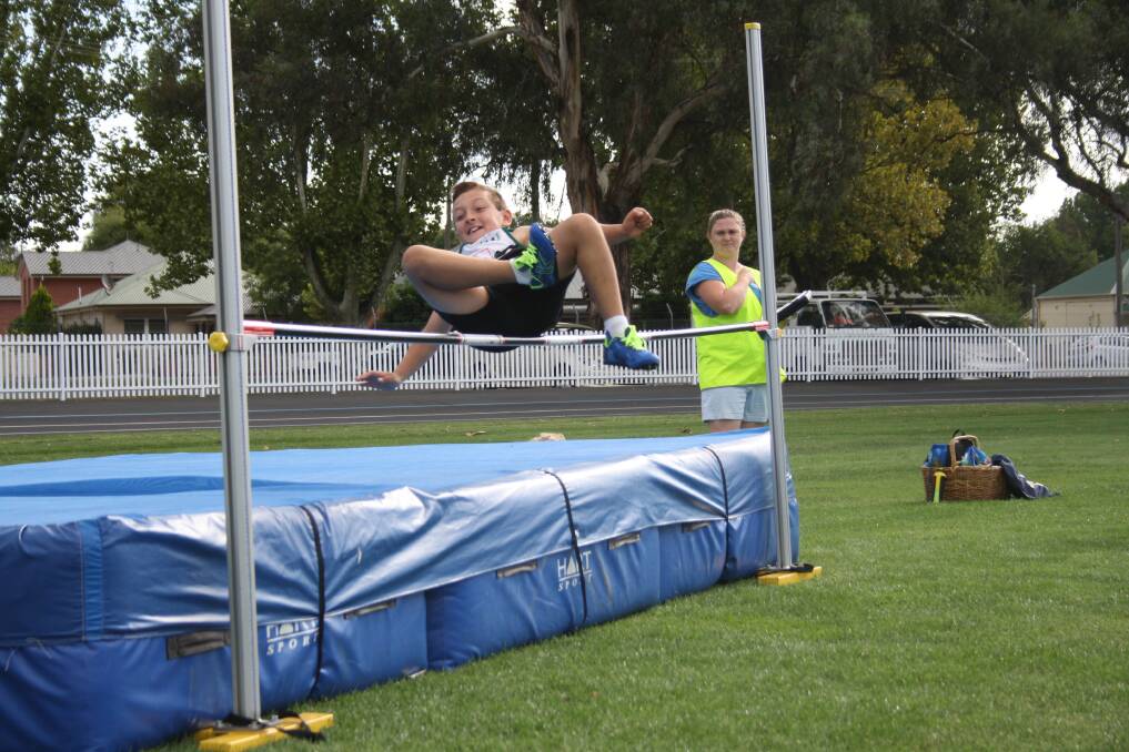 FLYING HIGH: The bar looks to be safely cleared by this member of the Bathurst Little Athletics Club.