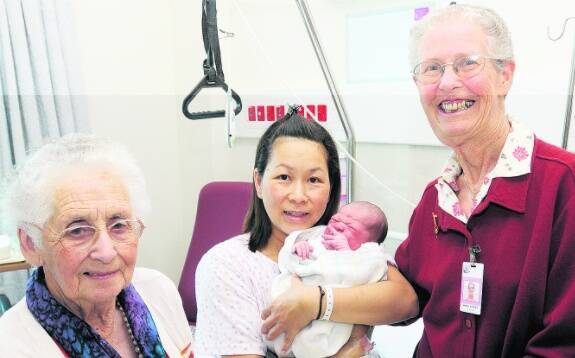 NEW YEAR’S GIFT: Bathurst Base Hospital Auxiliary patron Pat Waddell and vice president Wendy Stocks present Alex Gelling, the first baby born at the hospital in 2010 and his mum Michiko Gelling with a hand made shawl. Photo: PHILL MURRAY