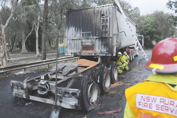 UNDER CONTROL: RFS members were called to a triple-0 truck fire 24 kilometres west of Bathurst on the Mitchell Highway. No one was injured when the truck caught alight after a tyre blew. Photo: CHRIS SEABROOK 020812ctrck1