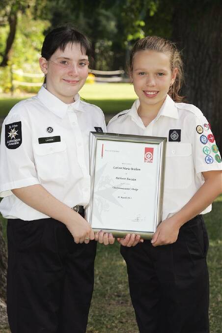 WELL DONE: Local St John Ambulance cadets Larissa Benham and Lauren Clemens, both 11, have been awarded the Commissioners Badge, the highest achievement in the organisation's junior ranks. Photo: PETER FORAN 121511fstjohns