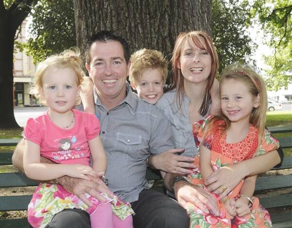 HISTORIC WIN: New Member for Bathurst Paul Toole pictured yesterday with his wife Jo and children Scout, 3, Rhayne, 9, and Keely, 7, relaxing in Machattie Park. Photo: CHRIS SEABROOK 032711cpaul1