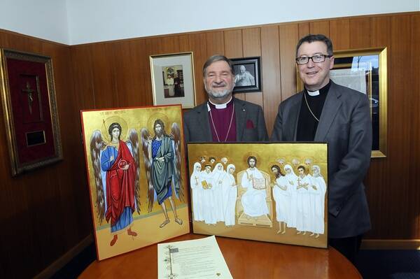 HISTORIC EVENT: Anglican Bishop Richard Hurford and Catholic Bishop Michael McKenna with the religious icons to be exchanged during next Thursday’s joint clergy day in Bathurst. Photo: PHILL MURRAY	 051712picons