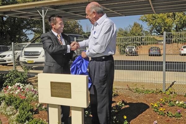 CONGRATULATIONS: Member for Bathurst Paul Toole and Garden Clubs of Australia Inc president Ken Bradley share a congratulatory handshake on Friday morning after opening the leisure and sensory garden at Bathurst Independent Living Skills. Photo: 041312pbils2