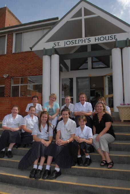 FULL HOUSE: Boarders from St Joseph’s House with Assistant Director of Boarding Annette Gainsford (back, second from left) and Director of Boarding Vicki Evans (front, right). 020911pmacs
