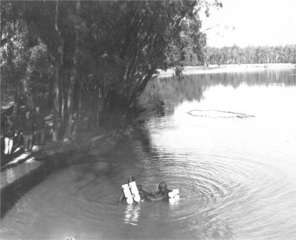WATERY GRAVE: Police divers in a fruitless search of the Murray River at Pumps Beach below Tocumwal looking for the remains of Don Mackay in 1983.makcay5