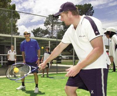 HELPING OUT: Tennis Australia coach development co-ordinator Joe Kubizniak (left) guides Wayne Lockie into a backhand at the orientation to coaching course in Eglinton yesterday. Photo: CHRIS SEABROOK