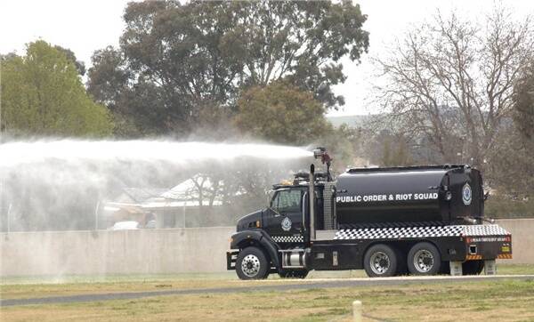 SAFE ENVIRONMENT: The NSW Police public order and riot squad’s water canon wasn’t needed over race weekend thanks to the dawn of a new era in the crowd’s behaviour. The water canon was being emptied on the lawns at the Bathurst Showground yesterday before heading back to Sydney. Photo: ZENIO LAPKA 101209zcanon2