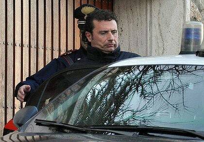 'Abandoned ship'... Costa Concordia cruise liner captain Francesco Schettino is escorted by a Carabinieri after his arrest.