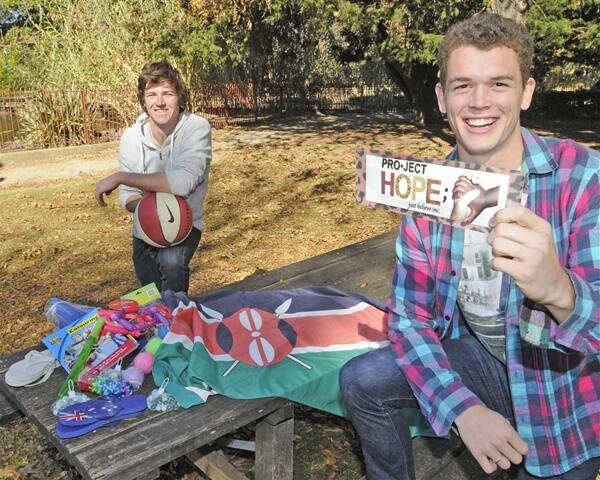 HELPING HANDS: Micky Booth and Sam Hutchins with some of the donated items they’re taking to villagers in Makindu when they fly out for Kenya. Photo: CHRIS SEABROOK 051711ckenya