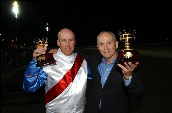 GOOD COMBINATION: Driver Glen McElhinney (left) shows off his second Gold Crown trophy alongside trainer John Tapp. Photo: CHRIS SEABROOK 032809crwn4g