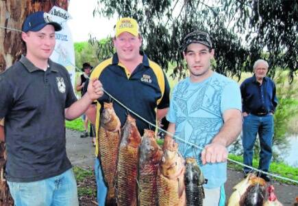 READY FOR A TOOHEYS OR TWO: Nathan Gearon and James Perry with  Tooheys representative Andrew "Struth" Smith offering congratulations on their capture of European Carp nudging seven kilograms in the BCF Carp Blitz yesterday at Bathurst. Photo: ZENIO LAPKA 110710zcarp4