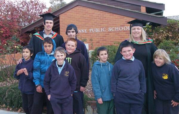CONGRATULATIONS: Graduates Adam Ryan and Laurie Clifford with students (from left) Graham Edwards, Will Lucas, Daemon Greenbank, Jaidyn Kelly, Daniel Harris, Stuart French, William Tatnell and Zoe Gavin. Photo: ZENIO LAPKA 051211zgrads