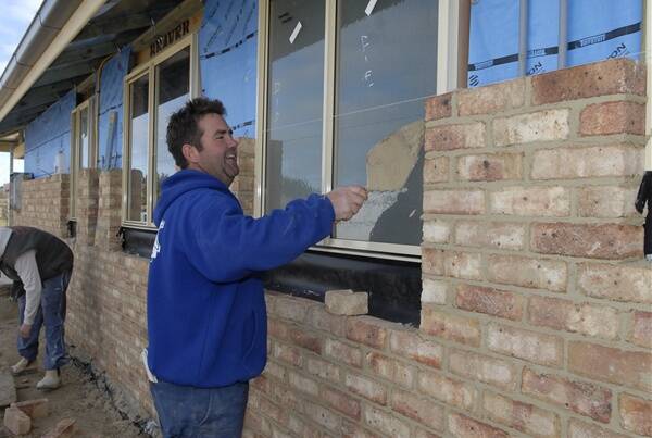GROWING: Bricklayer Greg Brack working on a new home in Coxs Lane at Eglinton on Friday. The village has been earmarked to double its population as part of Bathurst Regional Council's master plan to cater for a population of 50,000 residents by 2031. Photo: PHILL MURRAY 071511pbuild