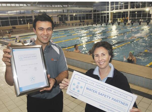 FIVE STAR: Bathurst Aquatic Centre manager Oliver Barclay accepts the Five Star Water Safety Partner certificate from Alison Middleton from Royal Life Saving NSW. Photo: CHRIS SEABROOK 072711cpool1
