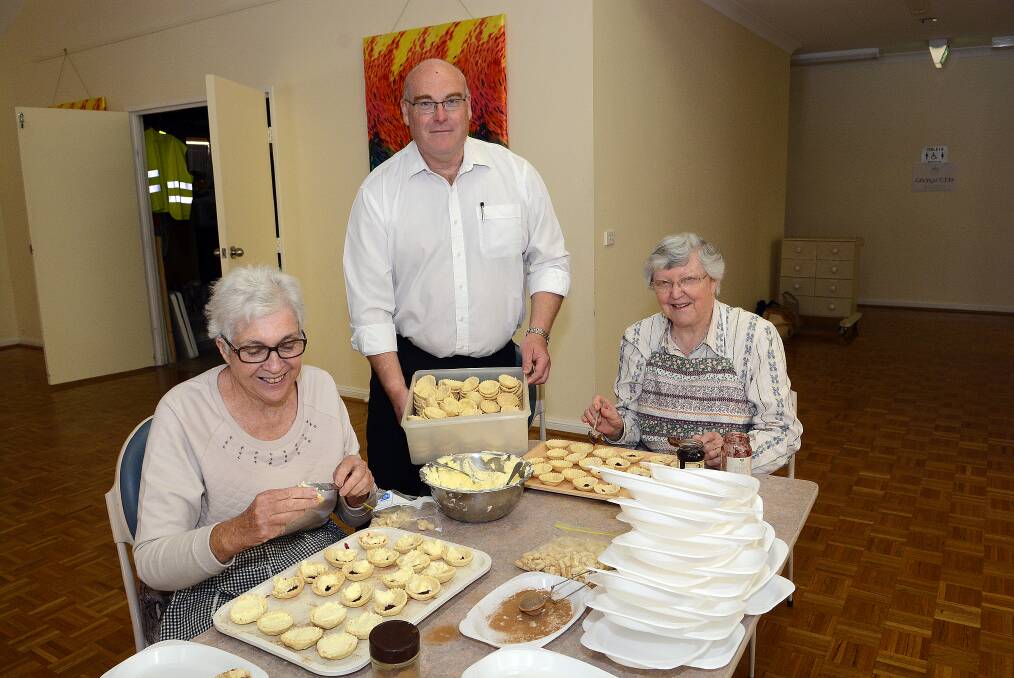 TREATS:  Marg Morris, Reverend Tim Fogo and Isobel Brainwood preparing for the Holy Trinity Kelso Spring Fair on Saturday, October 15 from 9am-1pm in the Parish and Community Hall in Gilmour Street, Kelso. 101614ptrinity