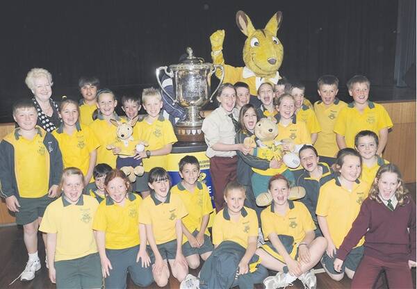 SAY WALLABIES!: Year 4 students at the Assumption School had their photos taken yesterday with the Bledisloe Cup and Wally the popular Wallabies mascot. Photo: CHRIS SEABROOK  090110cup2