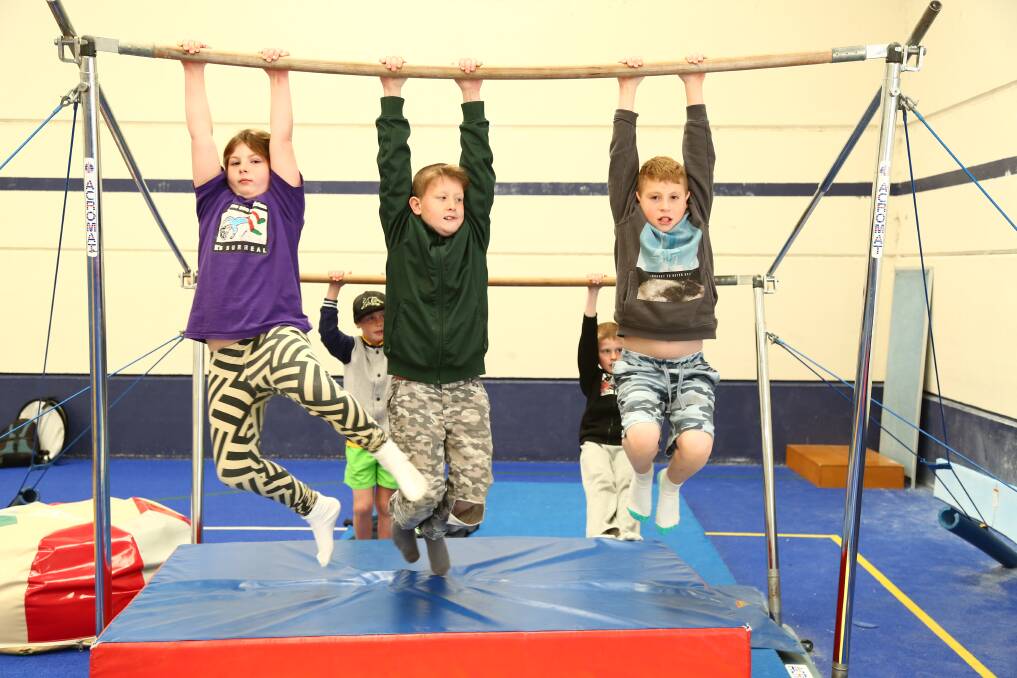 ALL THERE: Destiny Taylor, Dom Weston and Lachlan Penderakis teamed for a combined stretch during recent school holiday activities at Bathurst PCYC Club. 	070215pbpcyc3