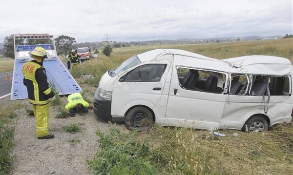 LUCKY ESCAPE: Eight occupants travelling with Interchange Bathurst were treated for minor injuries and shock after this Toyota HiAce commuter bus rolled from the Great Western Highway yesterday afternoon. Photo: CHRIS SEABROOK 012412crsh3