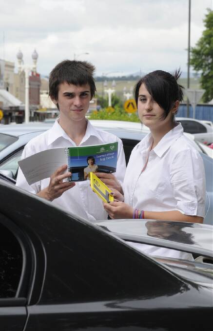 THE BOOK: Michael Coles, who can apply for his learner’s permit later this year, studies the Learner’s Log Book with his sister Dani Coles, who already has her permit. Photo: ZENIO LAPKA