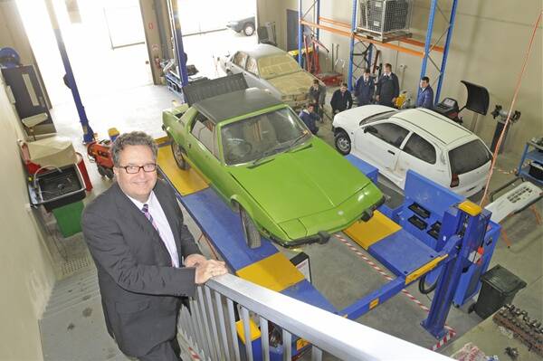 DELIGHTED: St. Stanislaus’ College headmaster John Edwards in the automotive bay of the school’s newly built trade training centre. Photo: CHRIS SEABROOK 083111cssc