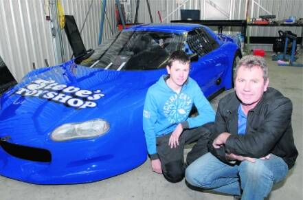 NEW TOY: Steve Shiels and his son Brad pose with the Chev Camaro Z28 which will make its racing debut at Wakefield Park. Photo: PHILL MURRAY 072910psteve2
