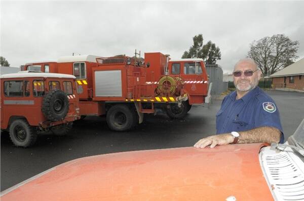 FOR SALE: Chifley Rural Fire Service inspector of learning and development/operations Keith Meehan with some of the former firefighting vehicles that are up for sale. Photo: CHRIS SEABROOK 052709cfiretrks1