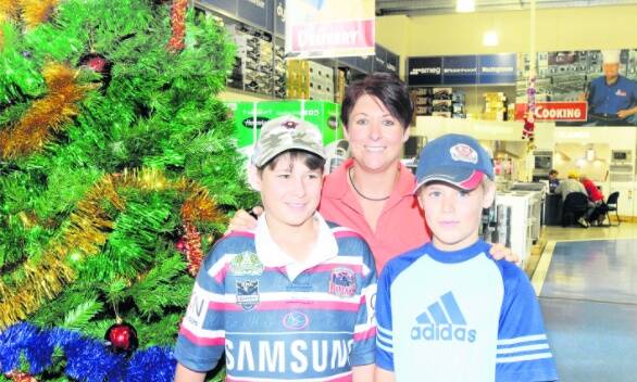 BARGAIN HUNTERS: Ryley, 10, Ryan, 12 and Lisa Oborn were looking for a bargain at The Good Guys yesterday. They were among the hundreds of shoppers taking advantage of the post-Christmas sales. Photo: ZENIO LAPKA