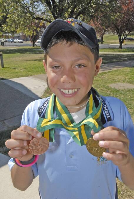 ON THE PODIUM: Carenne School student Will Lucas proudly displays the medals he won at the School Sport Australia Track and Field Championships in the Northern Territory. Photo: PHILL MURRAY 092211pwill