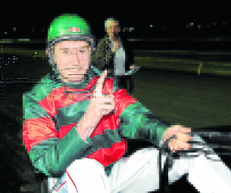 A TREASURED MOMENT: Andrew Donnelly was all smiles after winning his first ever race on Wednesday night. Photo: CHRIS SEABROOK 071812candrew1a