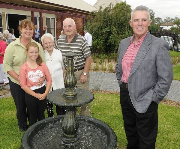 HONOURED: Vanessa and Annie White, Francie Morris (Danny White’s sister), Kevin Reece and John White, Danny’s son, were on hand for the dedication of the Danny White Memorial Fountain which forms the centrepiece of the new Daffodil Cottage garden. Photo: CHRIS SEABROOK 022812cgardn1