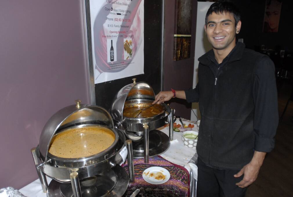 SPICE OF LIFE: Indus Village is the latest Indian restaurant to open its doors in Bathurst, bringing the total to four. Staff manager Ashok Adhikari shows off the popular buffet. Photo: CHRIS SEABROOK	 090512curry