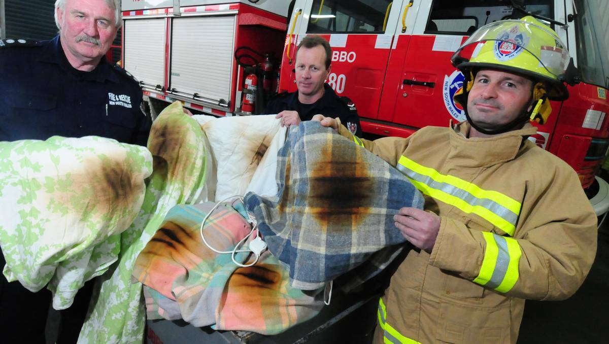 DUBBO: Station Officer Chris Sanders with firefighters Matt Knudsen and Graeme Combridge demonstrate an electric blanket that was seconds away from ignition. Photos: LOUISE DONGES.