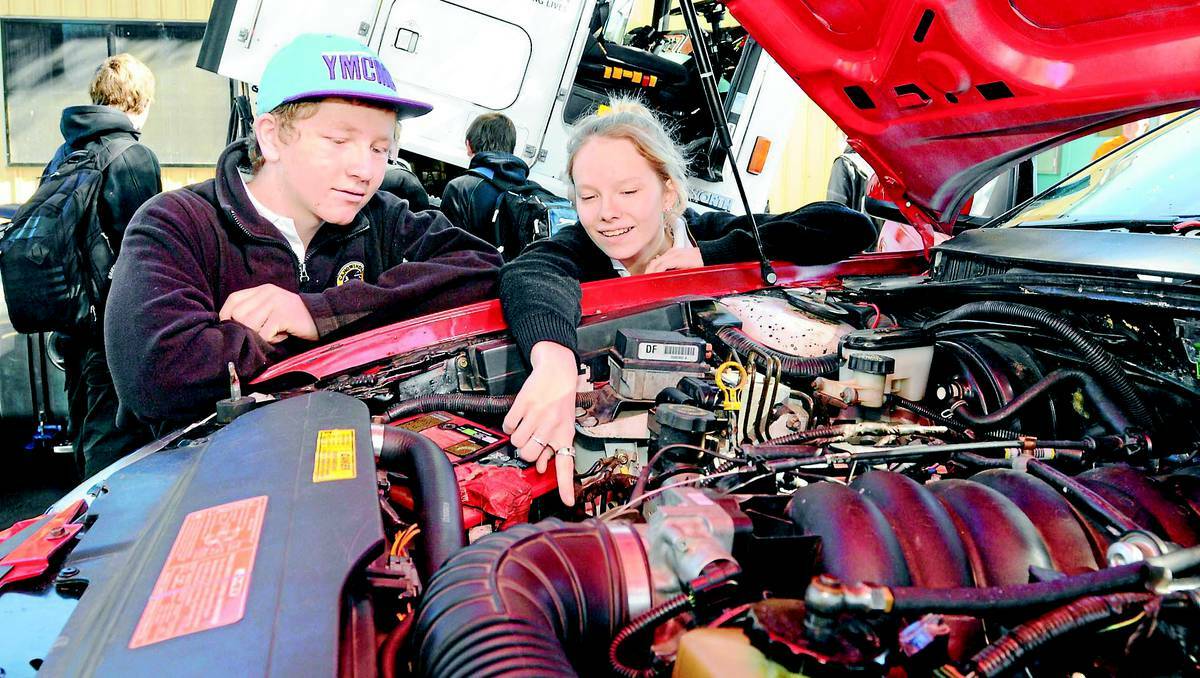 ORANGE: Canowindra High School students Michael Ogden and Mellanie Old check out the V8 race car on display at the Central West Careers and Job Expo at the Orange Function Centre. Photo: STEVE GOSCH 