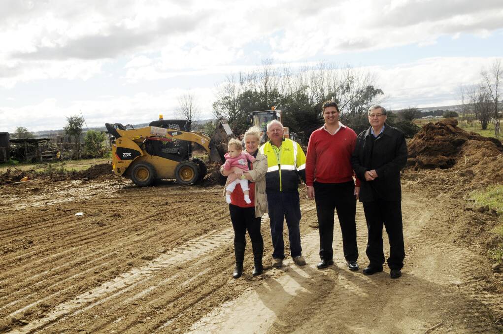 Narissa and Bella King, 11 months, Dave Pennells, Quinn King and Bruce Bolam take a look at the earthworks on the site of the new Milestones Early Learning Centre in Stanley Street. 