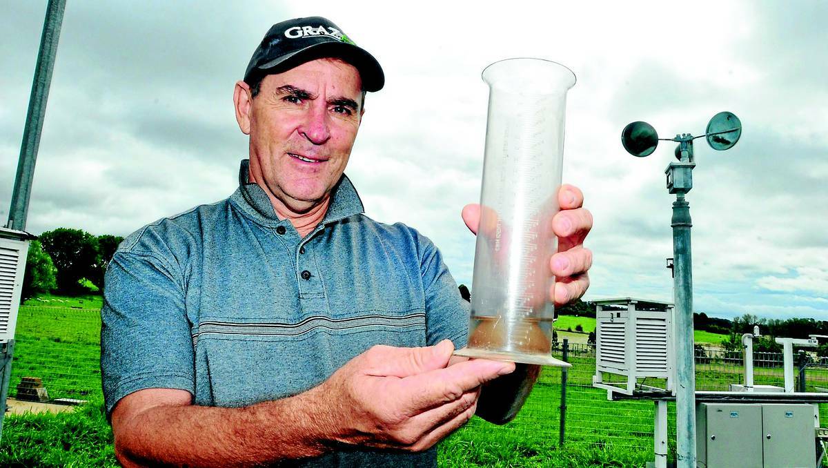 RECORDS SET Orange Agriculture Institute farm supervisor Pat Farrelly holds the institute’s rain gauge that measured a record rainfall for Orange yesterday. Photo JUDE KEOGH (flick across to see more photos).