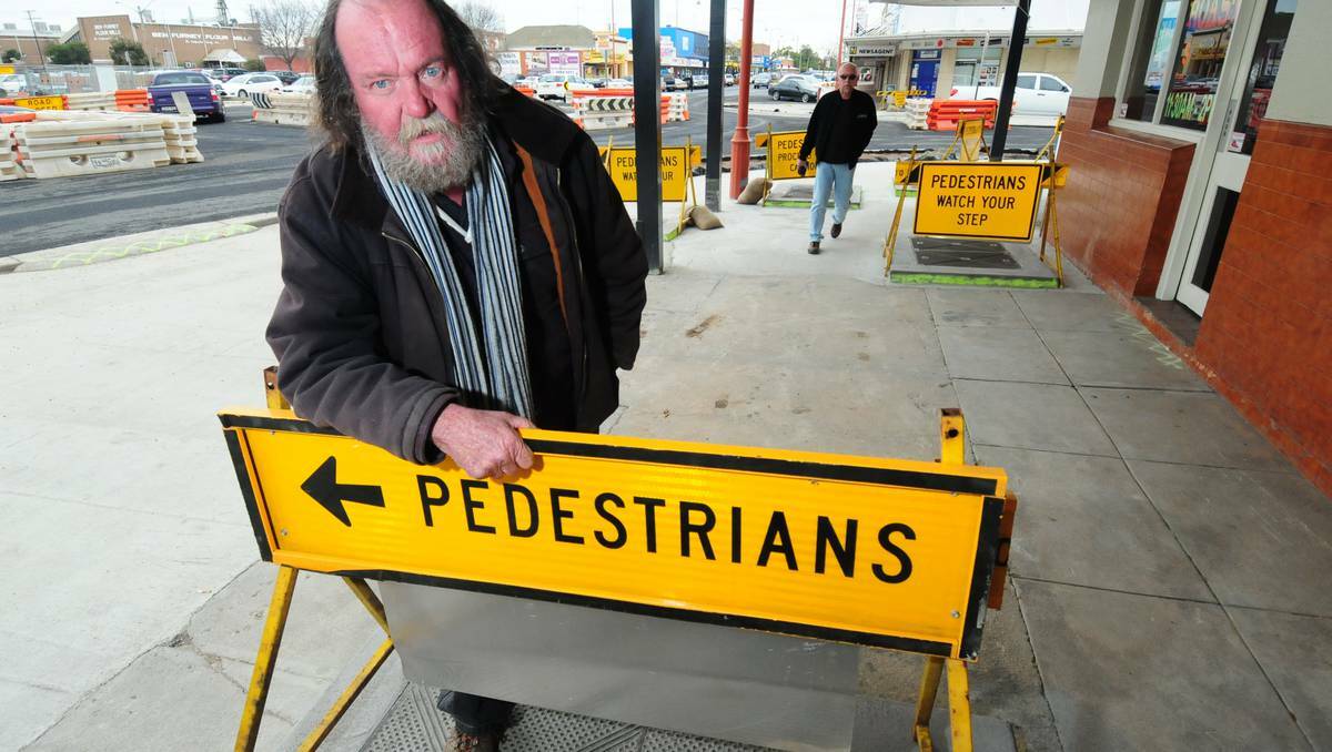 DUBBO: Talbragar Street trader Peter Neilson says business has dropped and pedestrians have been injured since construction of a new roundabout began. Photos: LOUISE DONGES