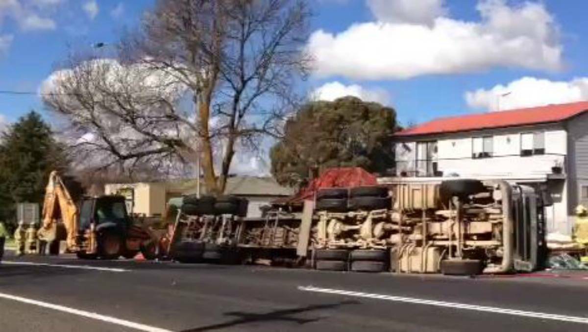 BLAYNEY: A logging truck rolled onto its side on the Mid Western Highway at Martha Street in Blayney.