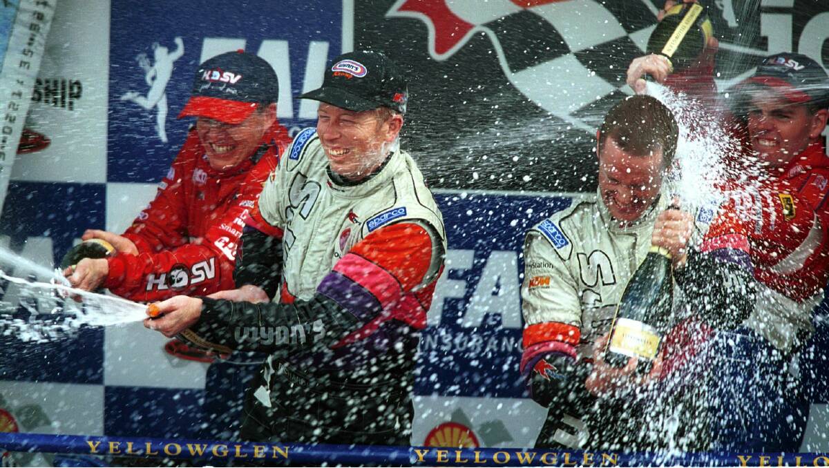 1999: Cameron McConville and Craig Lowndes of Australia join winners Steve Richards of Australia and Greg Murphy of New Zealand on the podium to celebrate after winning the FAI 1000. Photo: Getty Images