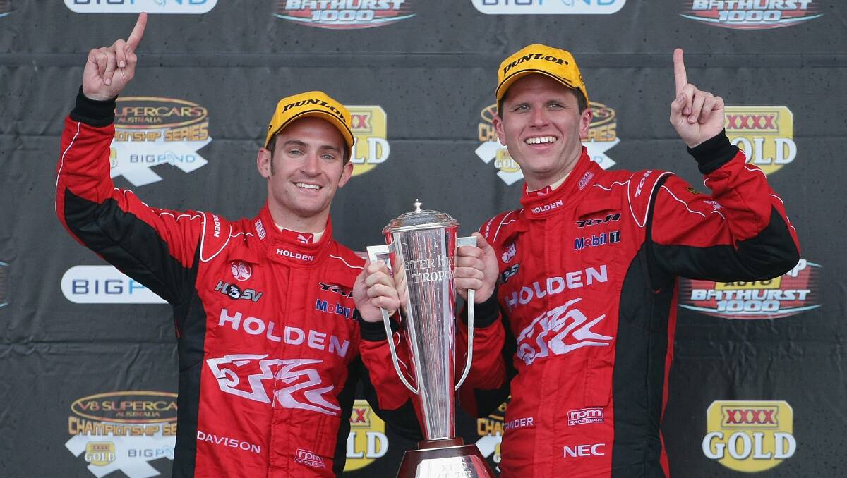 20009: Will Davison and Garth Tander drivers of the #2 Holden Racing Team Holden celebrate on the podium after winning the Bathurst 1000. Photo: Getty Images. 