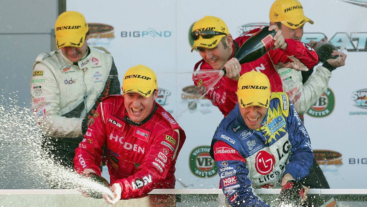 2005: Mark Skaife (front L) of the Holden Racing Team sprays champagne over fans after winning the Bathurst 1000. Photo: Getty Images. 