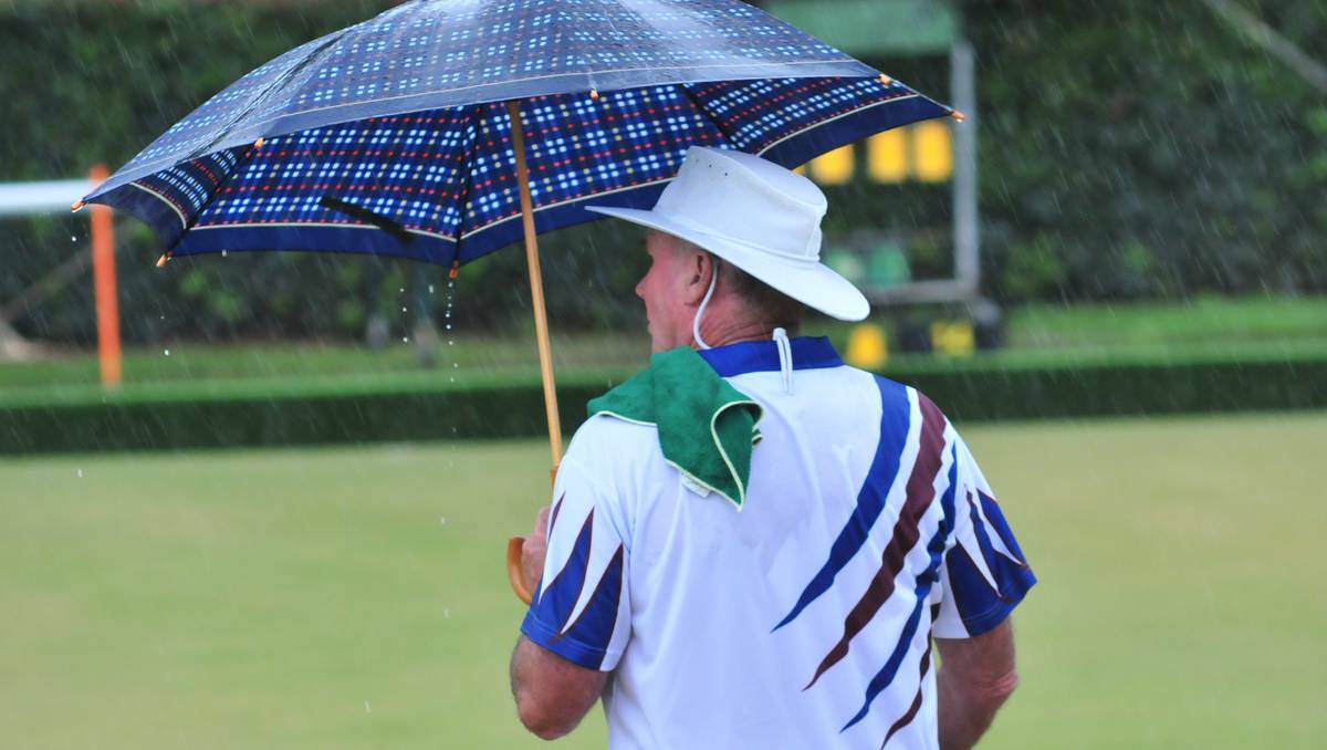HOT AND DRY Phil Westcott keeps dry at the Golden Eagle bowls tournament yesterday, despite recent rainfall, Orange recorded a hot and dry summer. Photo JUDE KEOGH  (flick across to see more photos).