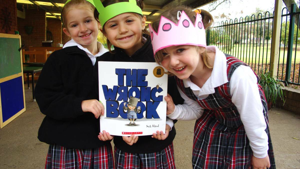 FANS: Dakayla Ellis, Jessi-May Williams and Cailee Anderson with The Wrong Book at Carinya Early Childhood Centre.