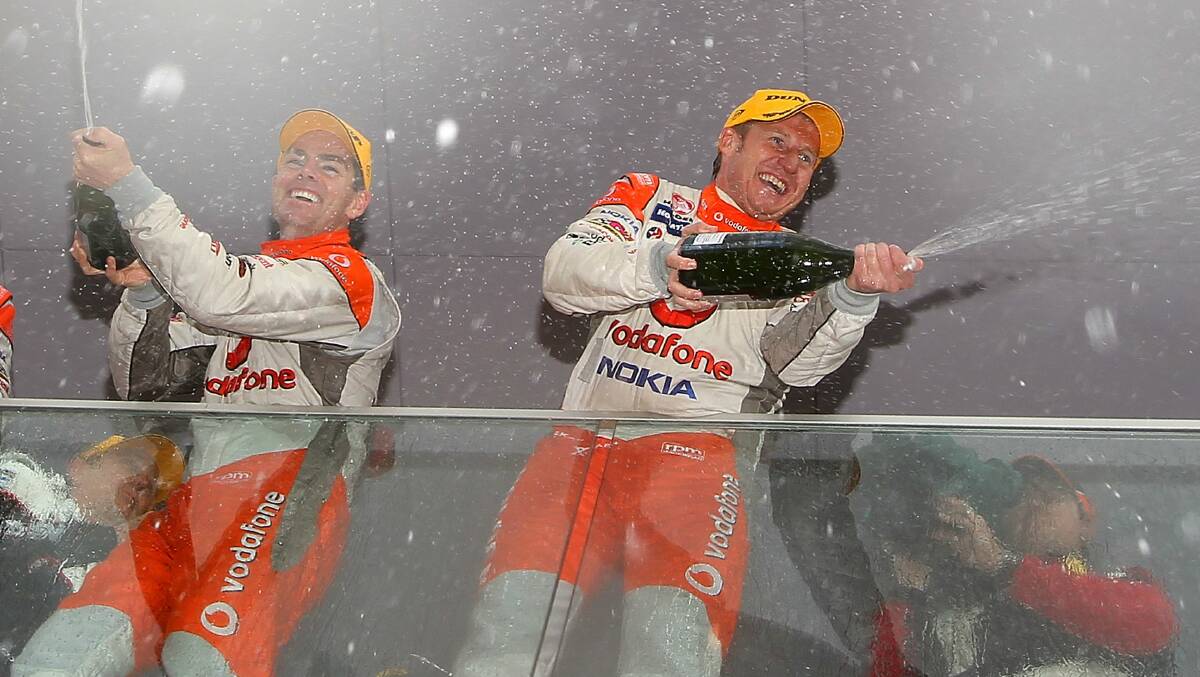 2010: Craig Lowndes celebrates on the podium with teammate Mark Skaife after they won the Bathurst 1000 in 2010. Photo: Getty Images