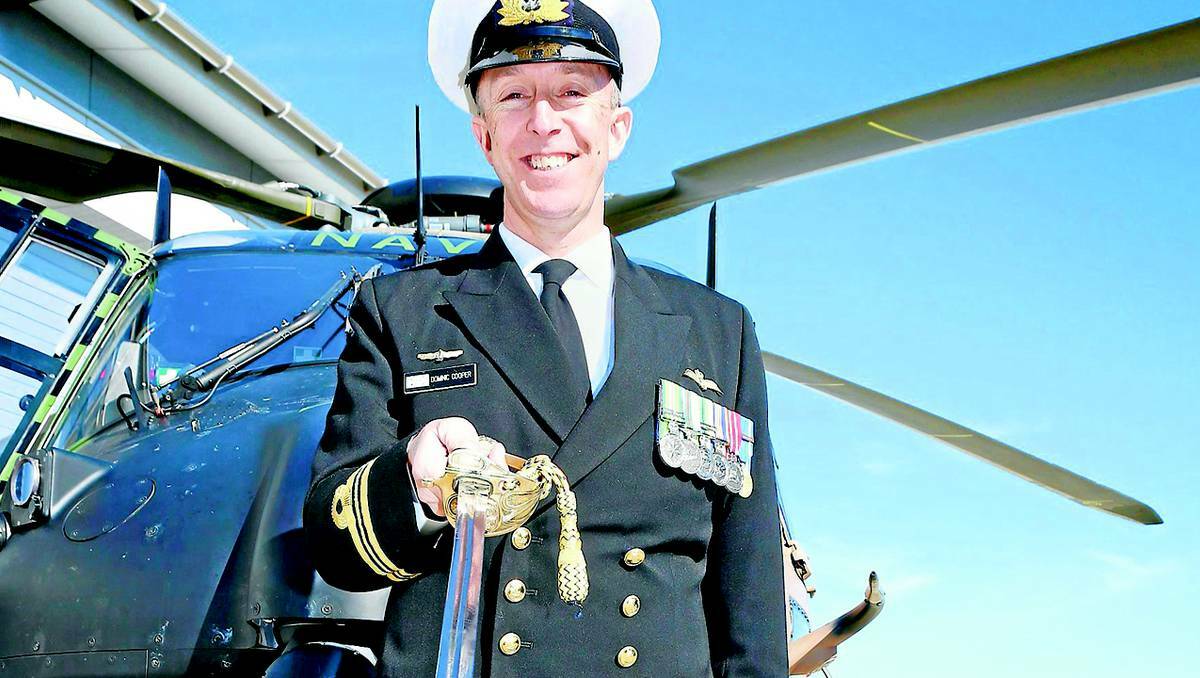 Executive officer 808 Squadron Lieutenant Commander Dom Cooper holds the ceremonial sword used for the commissioning of 808 Squadron. Picture: South Coast Register