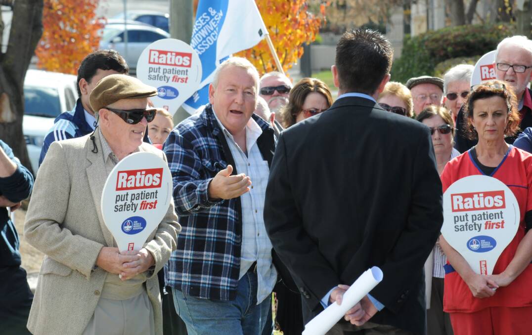 JUNE: Maurice Withyman addresses Member for Bathurst Paul Toole at the lunchtime rally outside Mr Toole’s Howick Street office. Photo: ZENIO LAPKA 053113zratio4