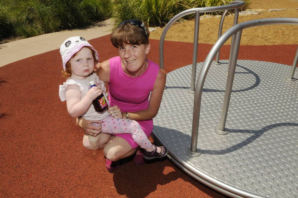 HOT WHEEL: Jenna Connor and her daughter Molly, next to the roundabout where the toddle received burns to her left hand and right leg. 020514pjenna