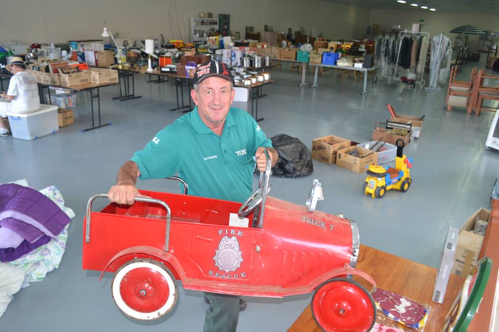 FEBRUARY: Cr Bobby Bourke at the former Dave’s Discounts store in Keppel Street, where items were auctioned  to raise funds for the Coonabarabran Bushfire Appeal. 021413auction