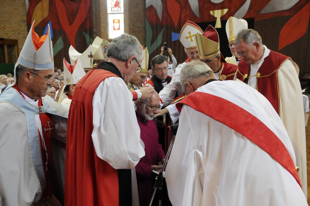 FEBRUARY: The bishops present lay their hands on the head of bishop-elect Ian Palmer. Photos: PHILL MURRAY 020913pbishop