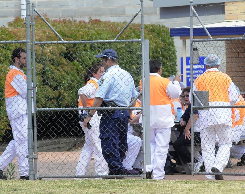PRECAUTIONS: Workers at Simplot’s fish processing plant at Kelso were moved outside while police conducted a search of the facility following Monday’s bomb threat. Photo: CHRIS SEABROOK 102813csimplt
