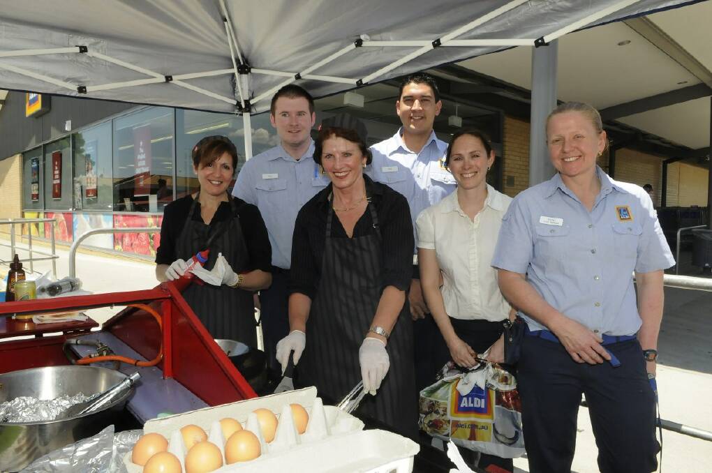 SNAPPED: Aldi staff members Ben Hope, Phil Renshaw, Renee Thatcher and Astrid Dufty with barbecue chefs  Lindia Tabotta and Katy Marple.